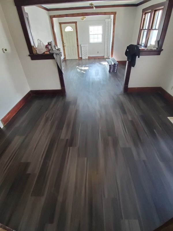 Recently renovated interior with new dark hardwood floors and white walls